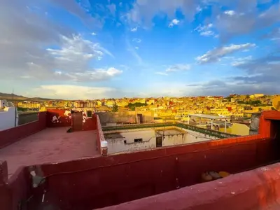 a view of a city from the roof of a building at vintage in Fès
