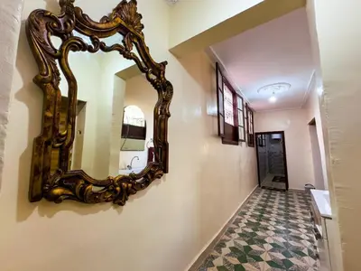 a hallway with a mirror on the wall at vintage in Fès