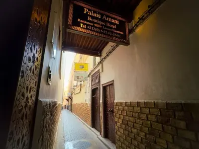 an alley with a sign on the side of a building at vintage in Fès