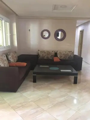 a living room with a couch and a coffee table at appartement tanger in Oulad Akkou