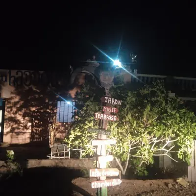 a sign in front of a house at night at امردول تسكوكت امرزكان ورزازات in Ouarzazate