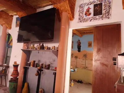 a living room with a flat screen tv on a wall at امردول تسكوكت امرزكان ورزازات in Ouarzazate