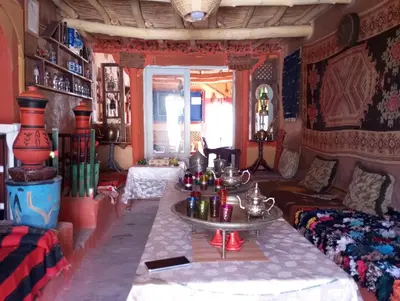 a living room with a table and a couch at امردول تسكوكت امرزكان ورزازات in Ouarzazate