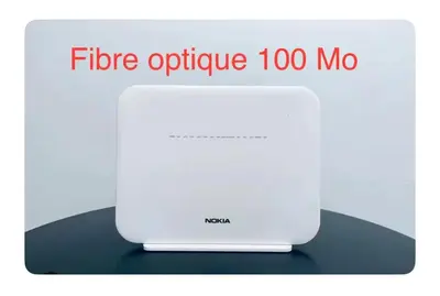 a white router with the text fibre optic too mo at Luxueux appartement à Prestigia avec Wifi Fibre 100Mo in Fès