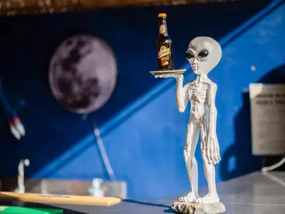 a toy skeleton holding a bottle of beer at Villa Roswell with Pool Privatisation in Heddad