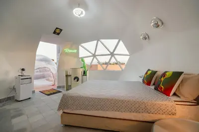 a bedroom with a large bed and a window at Villa Roswell with Pool Privatisation in Heddad