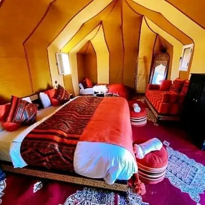 a bedroom with a large bed in a room at مرزوكة in Merzouga