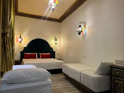 a bedroom with two beds and a ceiling at Riad Dar Mama Laila in Fès