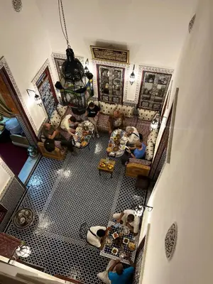 an overhead view of a living room with people in it at Riad Dar Mama Laila in Fès