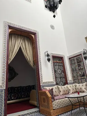 a living room with a couch and a table at Riad Dar Mama Laila in Fès