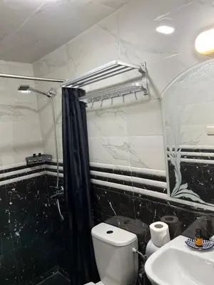 a bathroom with a toilet and a sink and a shower at Riad Dar Mama Laila in Fès