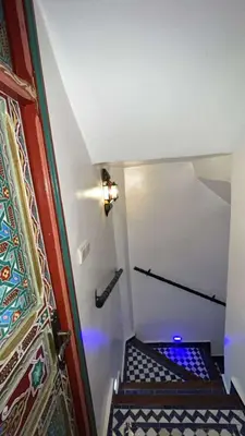a staircase with a blue light in a room at Riad Dar Mama Laila in Fès