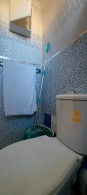 a bathroom with a mop next to a toilet at El Borj apartment in fes-Fes in Fès