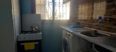 a kitchen with a sink and a washing machine at El Borj apartment in fes-Fes in Fès