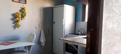 a small kitchen with a sink and a refrigerator at El Borj apartment in fes-Fes in Fès