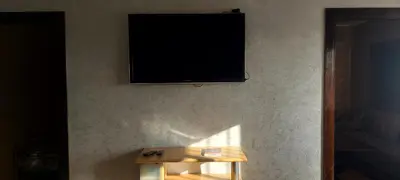 a flat screen tv hanging on a wall at El Borj apartment in fes-Fes in Fès