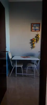 a table and two chairs in front of a wall at El Borj apartment in fes-Fes in Fès