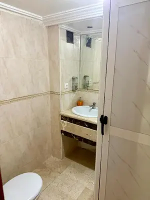 a bathroom with a toilet and a sink at Fabuleux appartement au Centre Ville avec Wifi 100 Mo in Fès