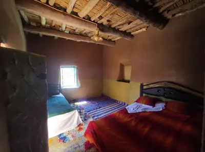 a bedroom with two beds and a window at Casa Rural Todra Gorges in Tinerhir