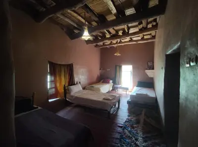 a large room with two beds and a window at Casa Rural Todra Gorges in Tinerhir