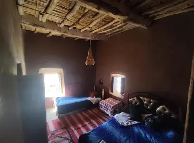 a living room with a bed and a window at Casa Rural Todra Gorges in Tinerhir
