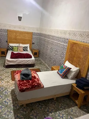 two beds in a hotel room with two bedsvisor at dar ben issa in Fès