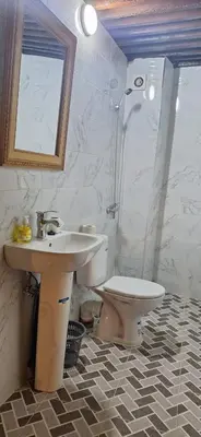 a bathroom with a sink and a toilet and a mirror at dar ben issa in Fès