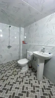 a white bathroom with a sink and a toilet at dar ben issa in Fès