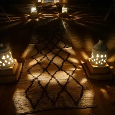 a room with candles and lights on the floor at Melody Desert Camp Merzouga in Merzouga