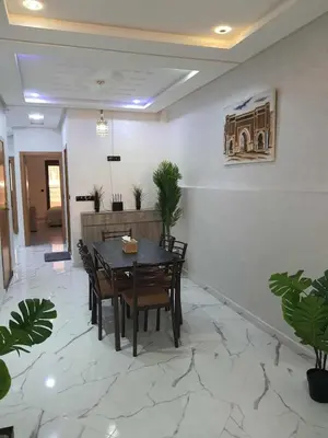 a dining room with a table and chairs at Meknes centre ville Appartement neuf moderne et bien équipé in Meknès