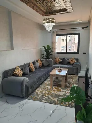 a living room with a couch and a table at Meknes centre ville Appartement neuf moderne et bien équipé in Meknès