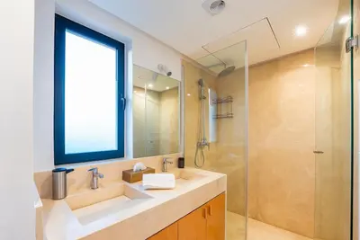 a bathroom with a sink and a glass shower at Villa SUNSET Marrakech in Marrakech