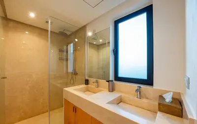 a bathroom with a sink and a glass shower at Villa SUNSET Marrakech in Marrakech