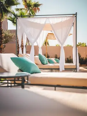 a group of beds on a patio at Villa SUNSET Marrakech in Marrakech