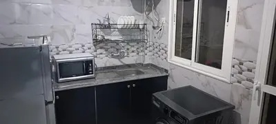 a small kitchen with a sink and a microwave at Appartement azrou in Azrou