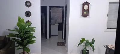 a hallway with a clock and a potted plant at Appartement azrou in Azrou