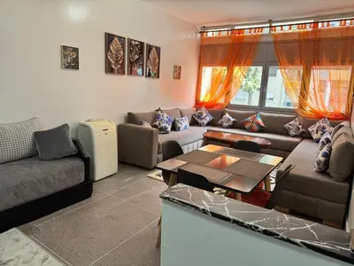 a living room with a couch and a table at Appartement Rabat Agdal in Oulad Akkou