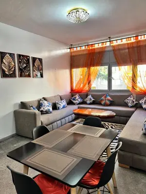 a living room with a couch and a table at Appartement Rabat Agdal in Oulad Akkou