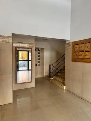 a large room with a staircase and a window at Appartement Rabat Agdal in Oulad Akkou