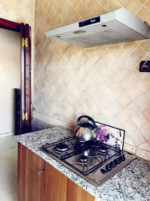 a tea kettle on top of a stove in a kitchen at Bel appartement 2 chambres au cœur de Marrakech in Oulad Akkou