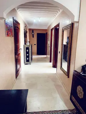 a hallway of a house with a room with doors at Bel appartement 2 chambres au cœur de Marrakech in Oulad Akkou