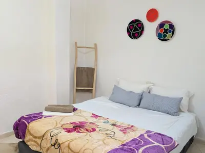 a bedroom with a bed with a blanket on it at Tayyurt Blue waves Beach house's in Oulad Akkou