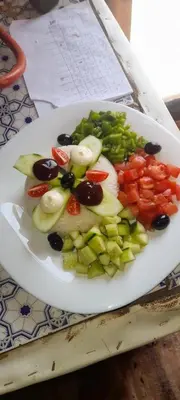 a plate of food with vegetables on a table at Camel desert camp in Merzouga