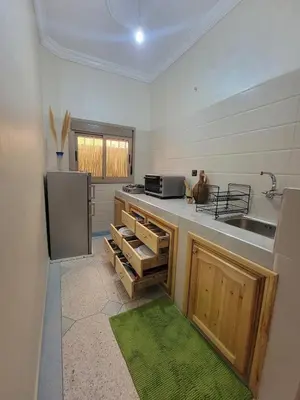a kitchen with a sink and a stove top oven at Blue Palm apartment in Ouarzazate