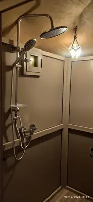 a shower in a bathroom with a glass door at Sahara Experience Luxury Camp in Merzouga