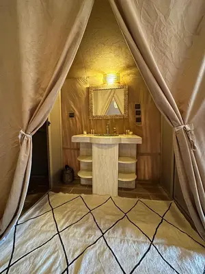 a bathroom with a sink and a mirror at Sahara Experience Luxury Camp in Merzouga