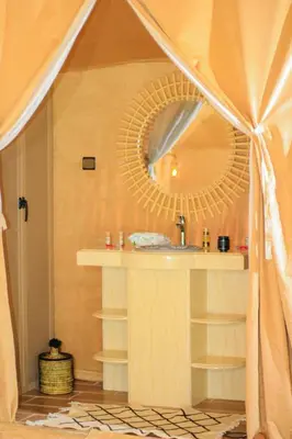 a bathroom with a sink and a mirror at Sahara Experience Luxury Camp in Merzouga