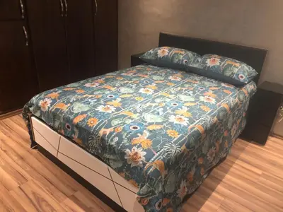 a bed with a colorful blanket on top of it at Apartement in saada fez in Fès
