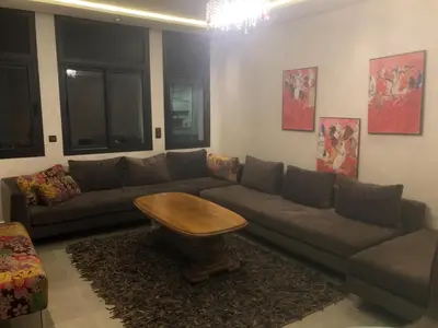 a living room with a couch and a table at Apartement in saada fez in Fès
