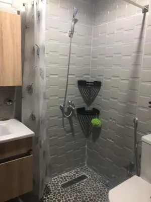 a bathroom with a shower with a toilet and a sink at Apartement in saada fez in Fès